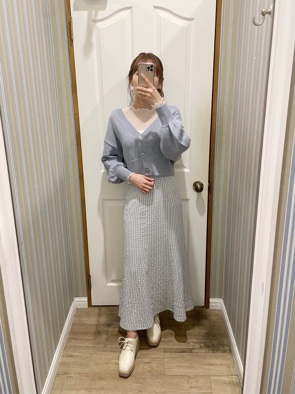 ブルー系のカーディガン/ボレロ、ブルー系のスカート、ホワイト系のローファーを着用したレディースの春コーディネートの3枚目の写真