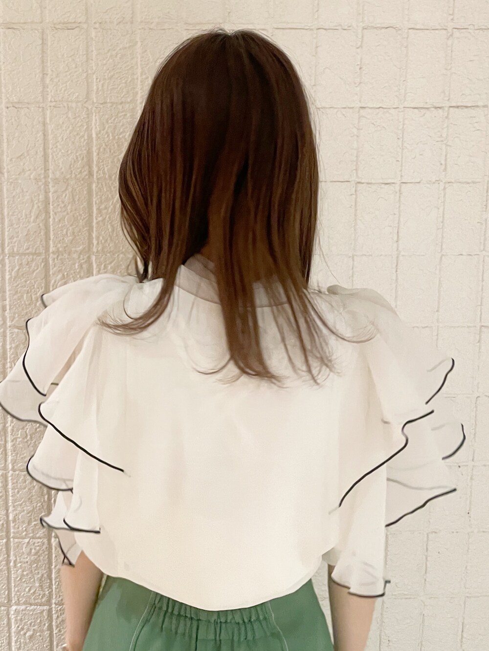 ホワイト系のシャツ/ブラウス、グリーン系のスカート、ホワイト系のパンプスを着用したレディースの春コーディネートの7枚目の写真