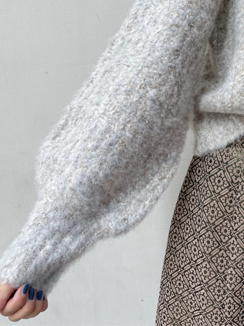 ブラック系のブーツ、ベージュ系のニット/セーター、ゴールド系のスカートを着用したレディースの秋コーディネートの8枚目の写真