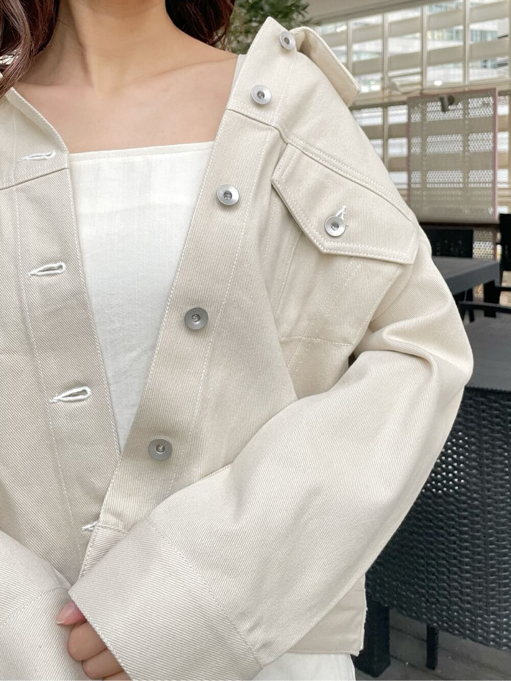 ベージュ系のデニムジャケット、ホワイト系のワンピース、ホワイト系のローファーを着用したレディースの春コーディネートの10枚目の写真