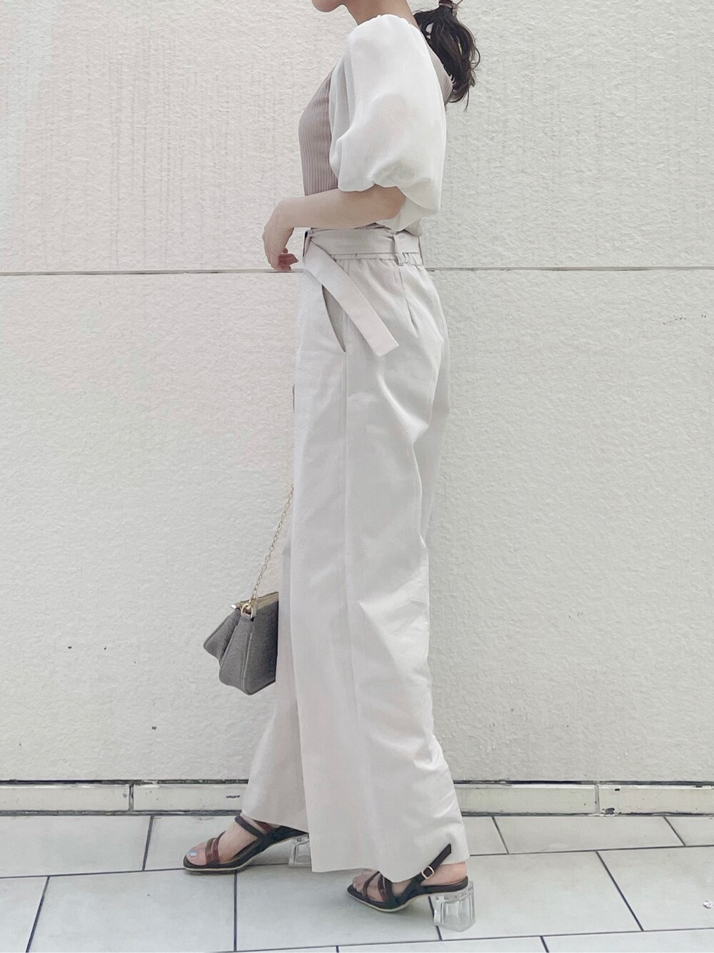 ベージュ系のショルダーバッグ、ホワイト系のその他パンツ、ブラウン系のサンダルを着用したレディースの春コーディネートの3枚目の写真