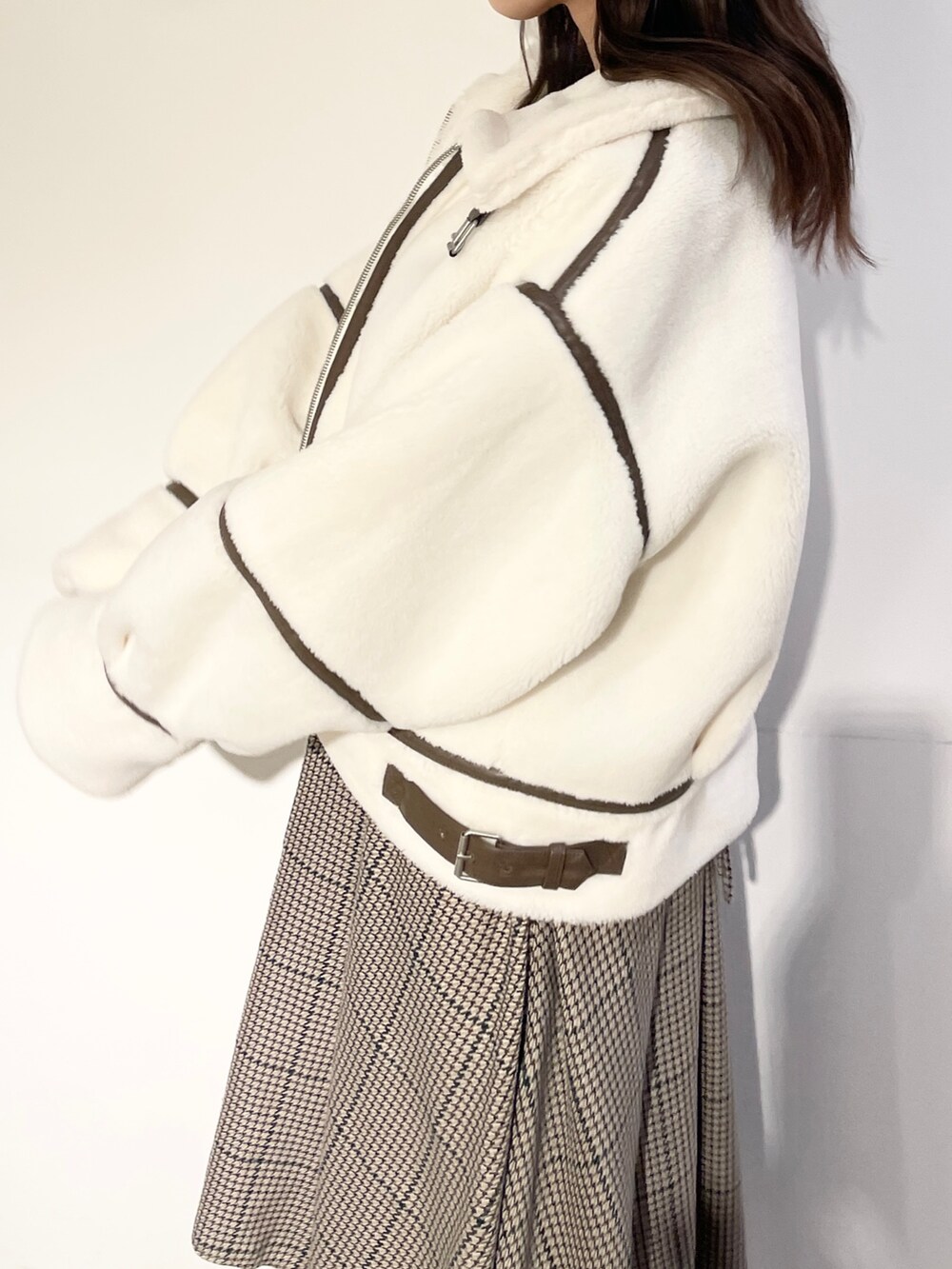 ブラウン系のワンピース、ベージュ系のブーツ、ホワイト系のブルゾンを着用したレディースの秋コーディネートの7枚目の写真