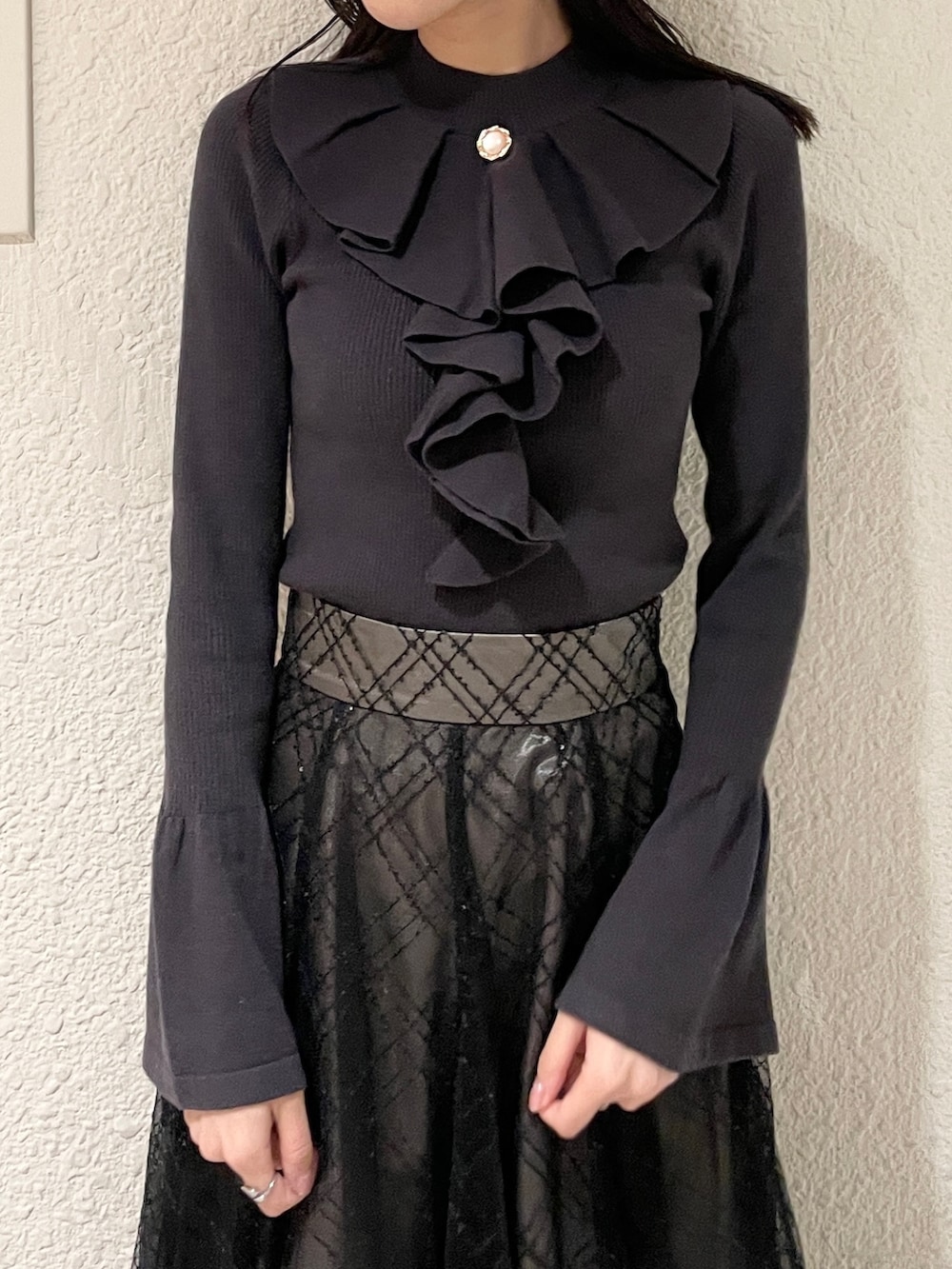 ブラック系のブーツ、ブラック系のニット/セーター、ブラック系のスカートを着用したレディースの冬コーディネートの4枚目の写真