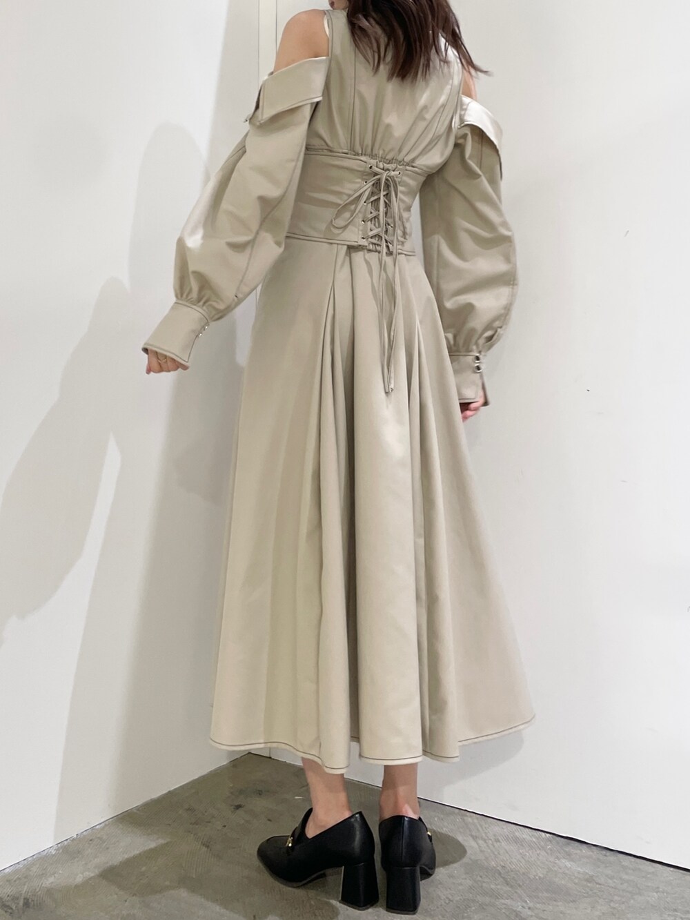 ブラック系のローファー、ホワイト系のワンピース、ベージュ系のカーディガン/ボレロを着用したレディースの秋コーディネートの3枚目の写真