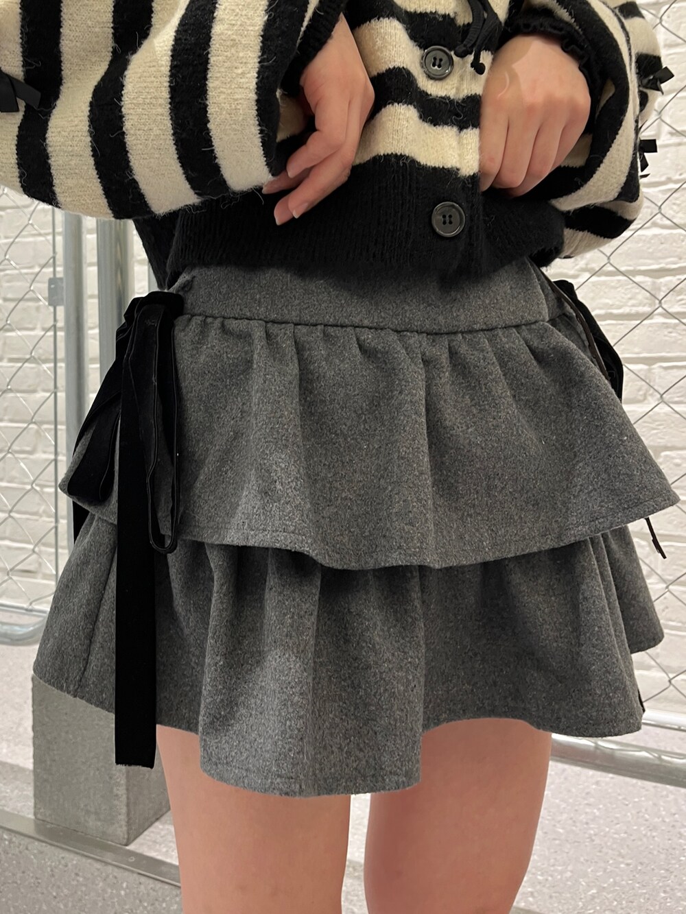 その他のカーディガン/ボレロ、ブラック系のTシャツ/カットソー、グレー系のスカートを着用したレディースの冬コーディネートの8枚目の写真