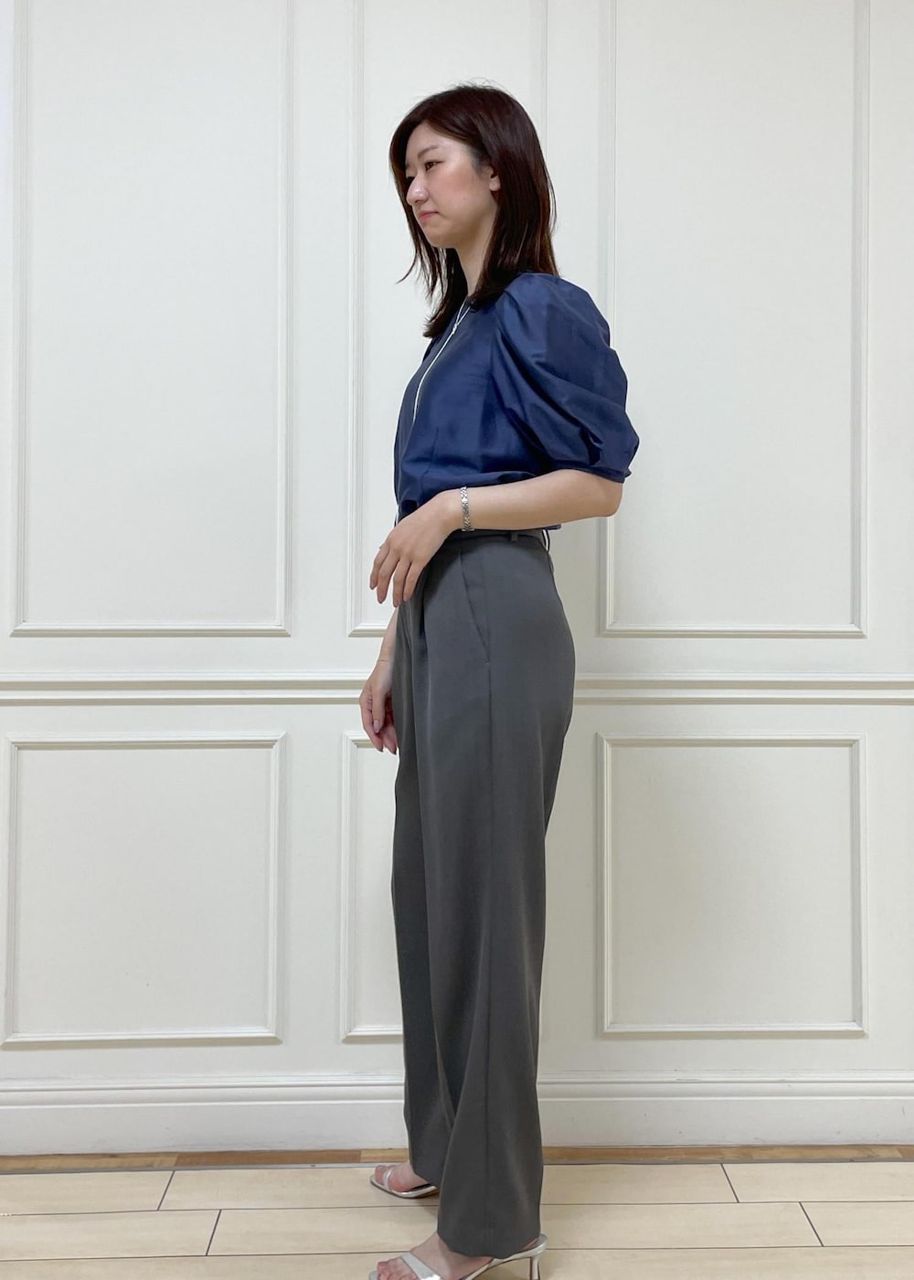 シルバー系のサンダル、グレー系のその他パンツ、ブラック系のハンドバッグを着用したレディースの春コーディネートの2枚目の写真