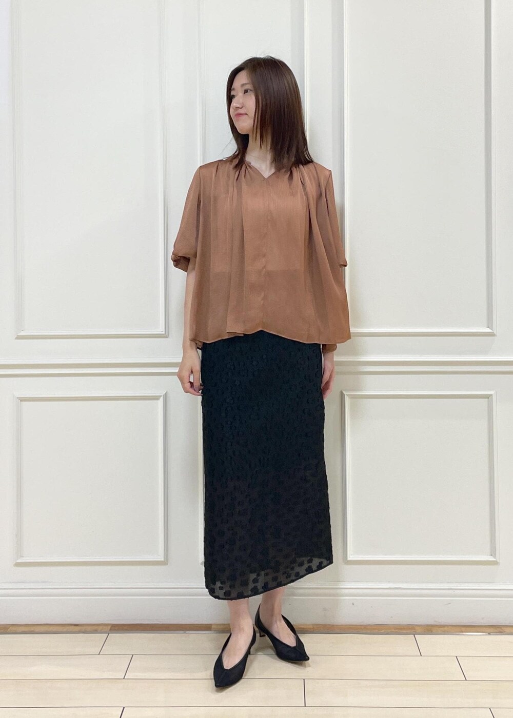 ブラック系のスカート、ホワイト系のハンドバッグ、レッド系のシャツ/ブラウスを着用したレディースの夏コーディネートの2枚目の写真