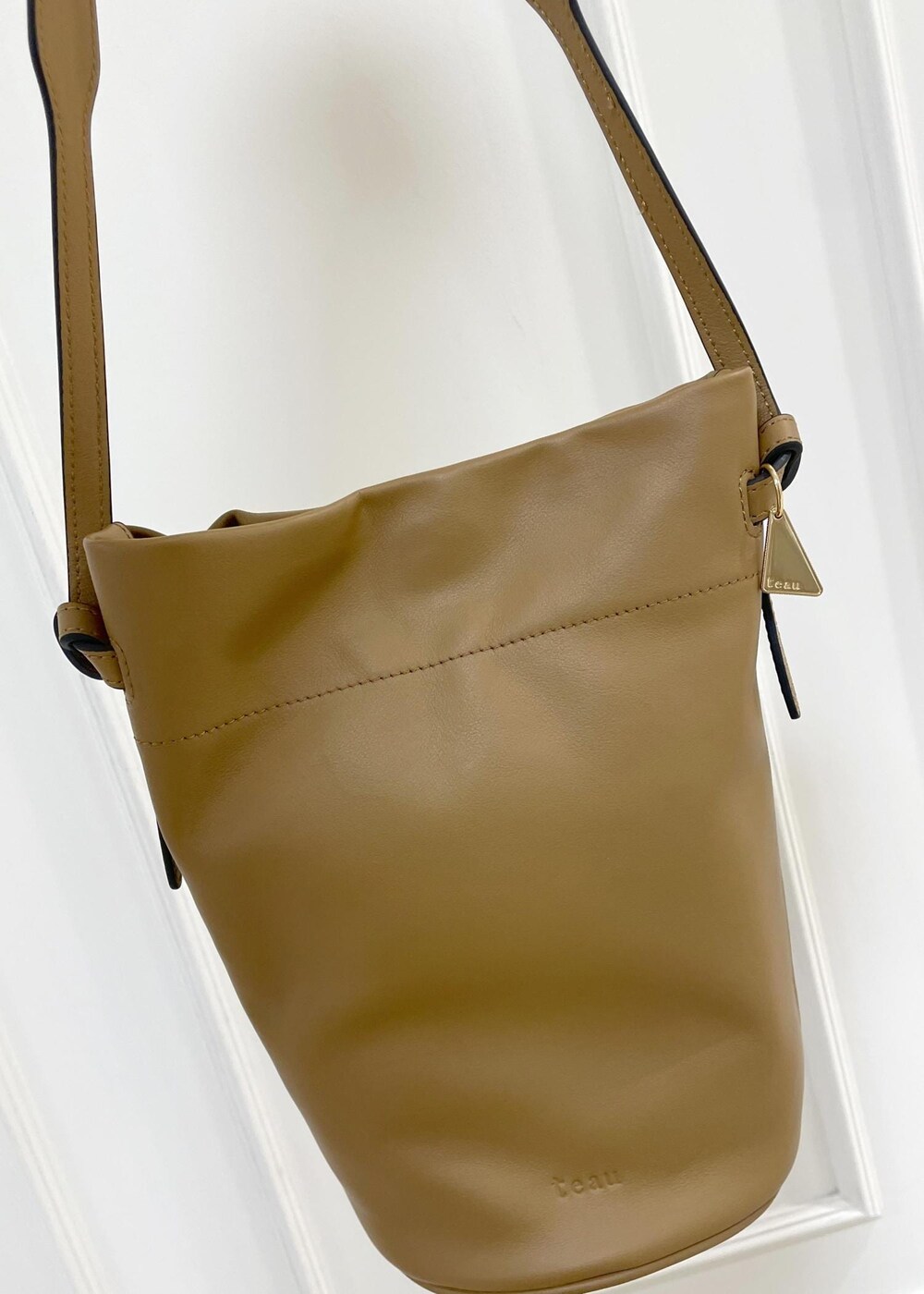 ブラック系のワンピース、ベージュ系のニット/セーター、イエロー系のハンドバッグを着用したレディースの秋コーディネートの6枚目の写真