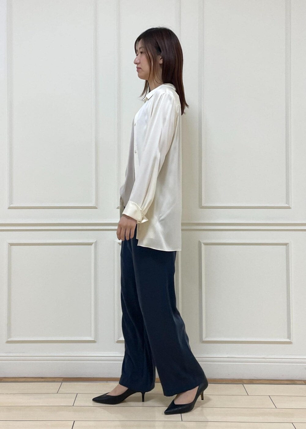 ブラック系のパンプス、ベージュ系のキャミソール、ホワイト系のシャツ/ブラウスを着用したレディースの春コーディネートの2枚目の写真