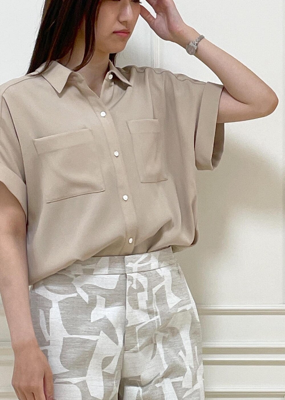 ブラック系のショルダーバッグ、ホワイト系のサンダル、ベージュ系のシャツ/ブラウスを着用したレディースの春コーディネートの5枚目の写真