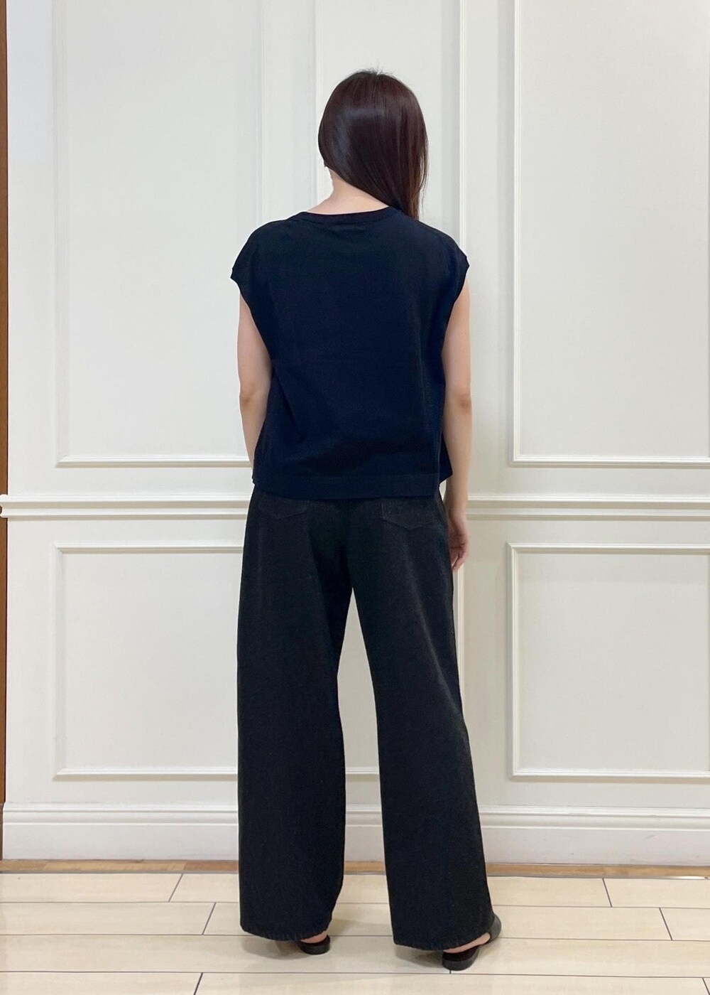 ブラック系のデニムパンツ、ベージュ系のショルダーバッグ、ブルー系のニット/セーターを着用したレディースの春コーディネートの7枚目の写真