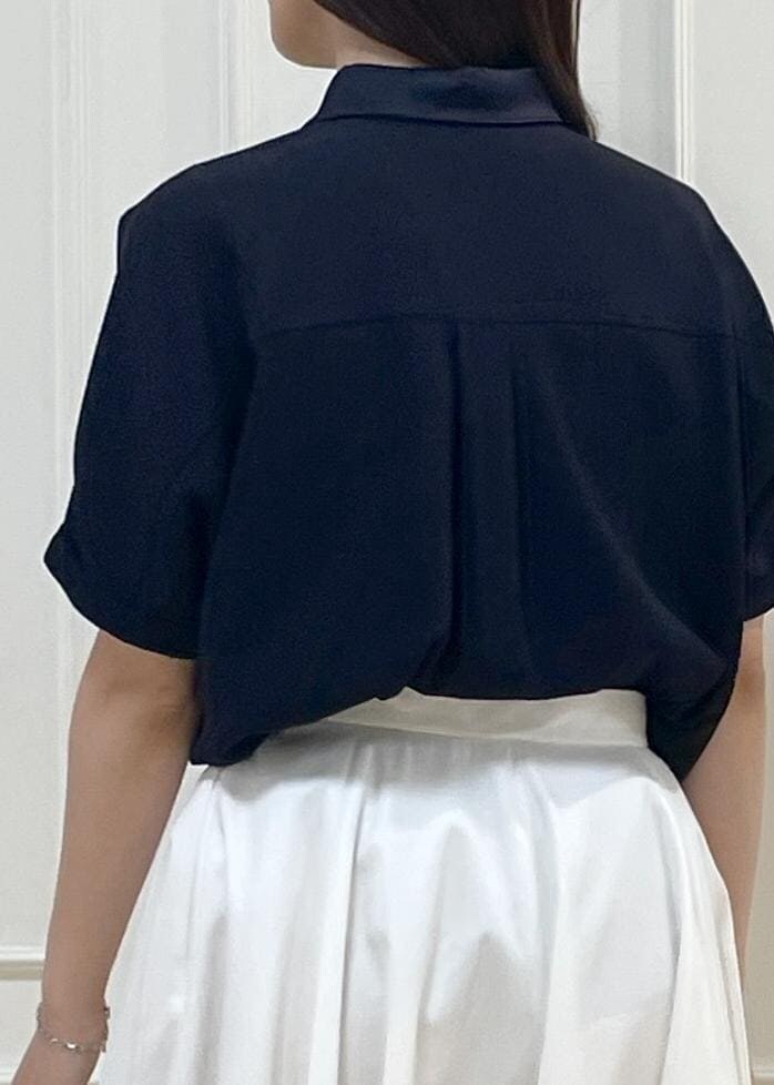 ブラック系のハンドバッグ、ホワイト系のスカート、ホワイト系のニット/セーターを着用したレディースの春コーディネートの9枚目の写真