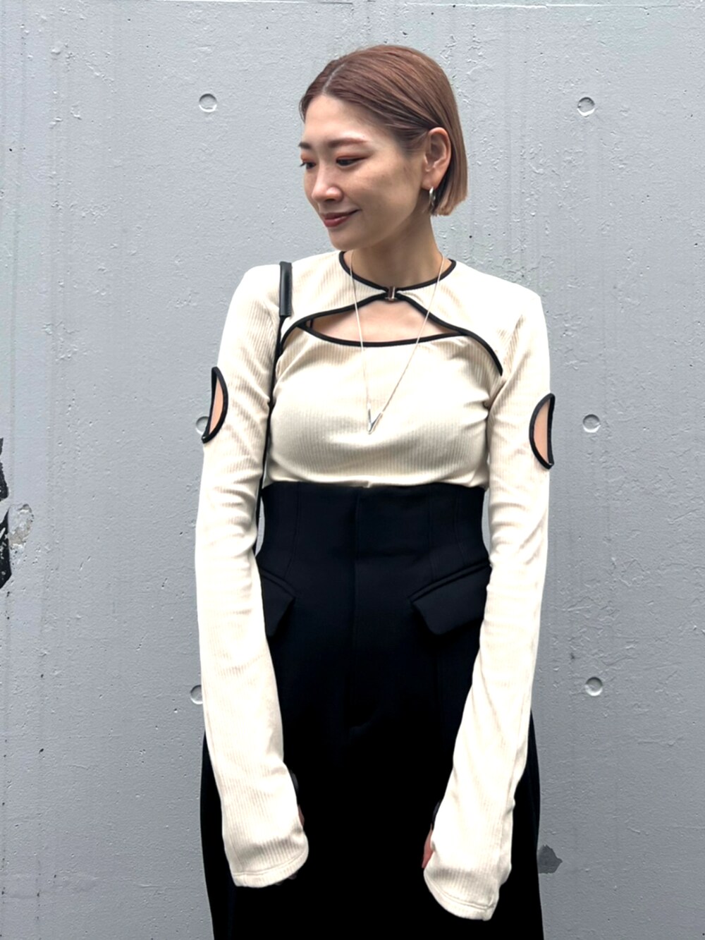 ブラック系のブーツ、ブラック系のスカートを着用したレディースの秋コーディネートの4枚目の写真