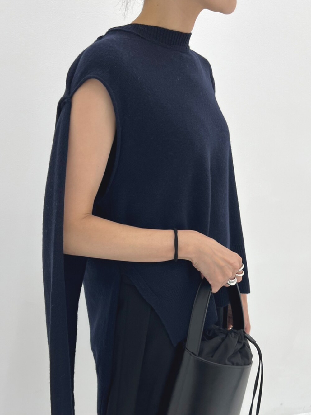 ブラック系のハンドバッグ、ブラック系のスリッポンを着用したレディースの秋コーディネートの4枚目の写真