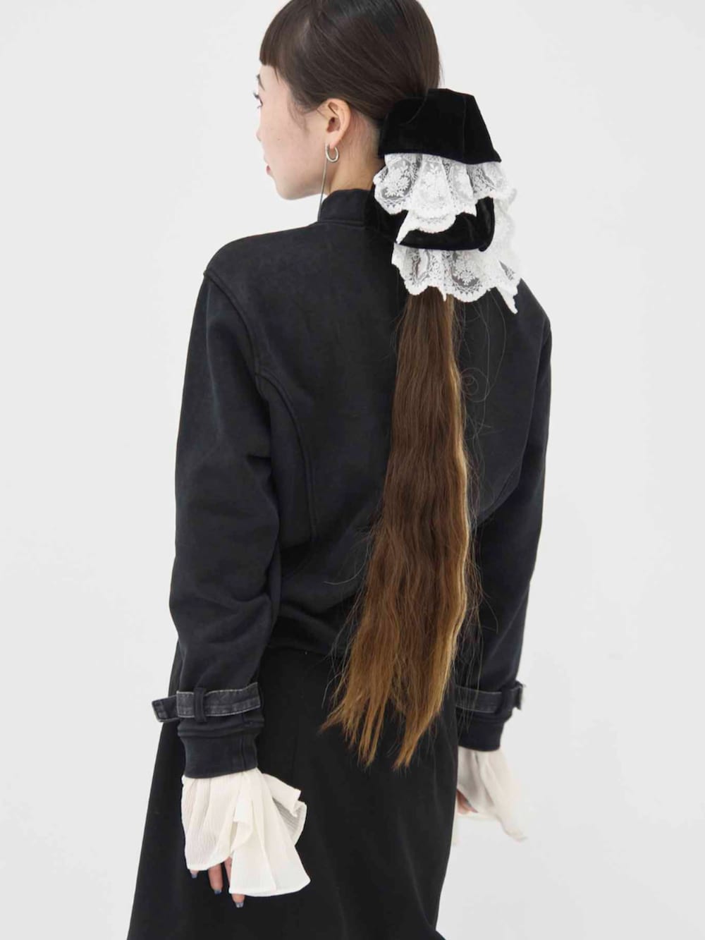 ホワイト系のシュシュを着用したレディースの冬コーディネートの2枚目の写真