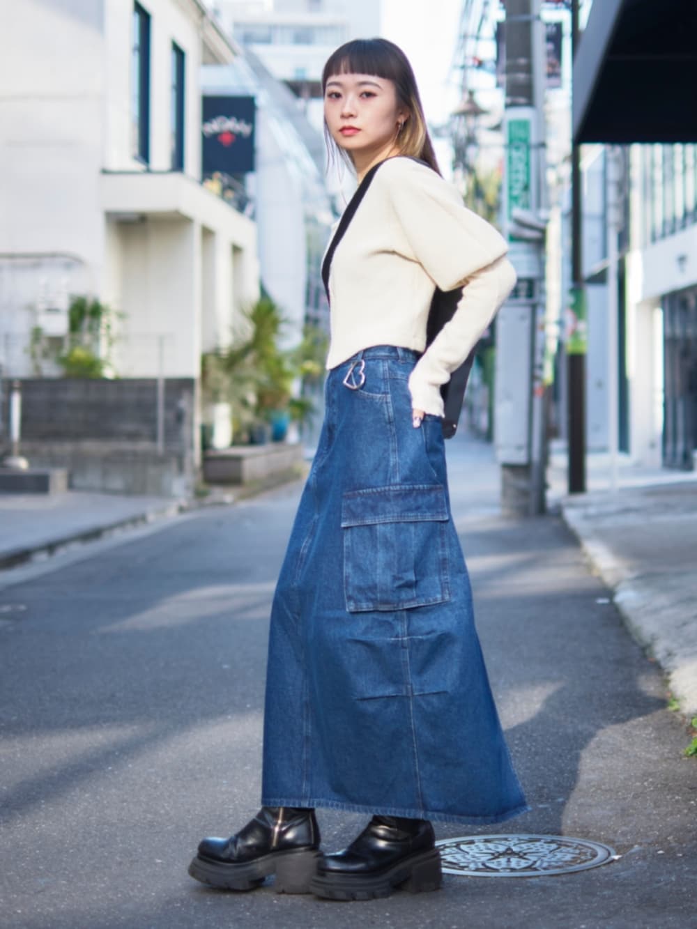 ブルー系のデニムスカート、シルバー系のチャームを着用したレディースの冬コーディネートの2枚目の写真