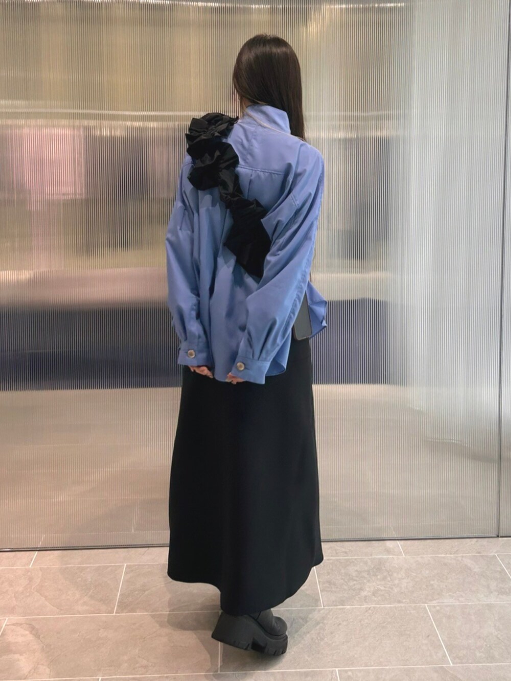 ブラック系のブーツ、ブルー系のシャツ/ブラウス、ブラック系のスカートを着用したレディースの秋コーディネートの3枚目の写真