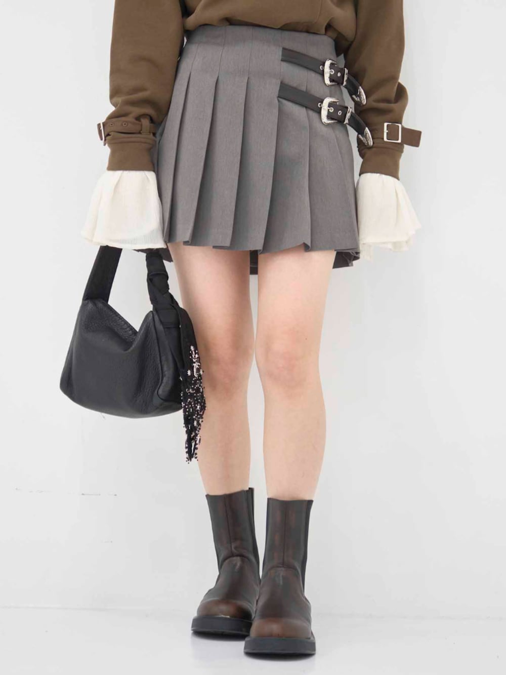 ブラウン系のスウェット、グレー系のスカート、ブラック系のバンダナ/スカーフを着用したレディースの冬コーディネートの4枚目の写真