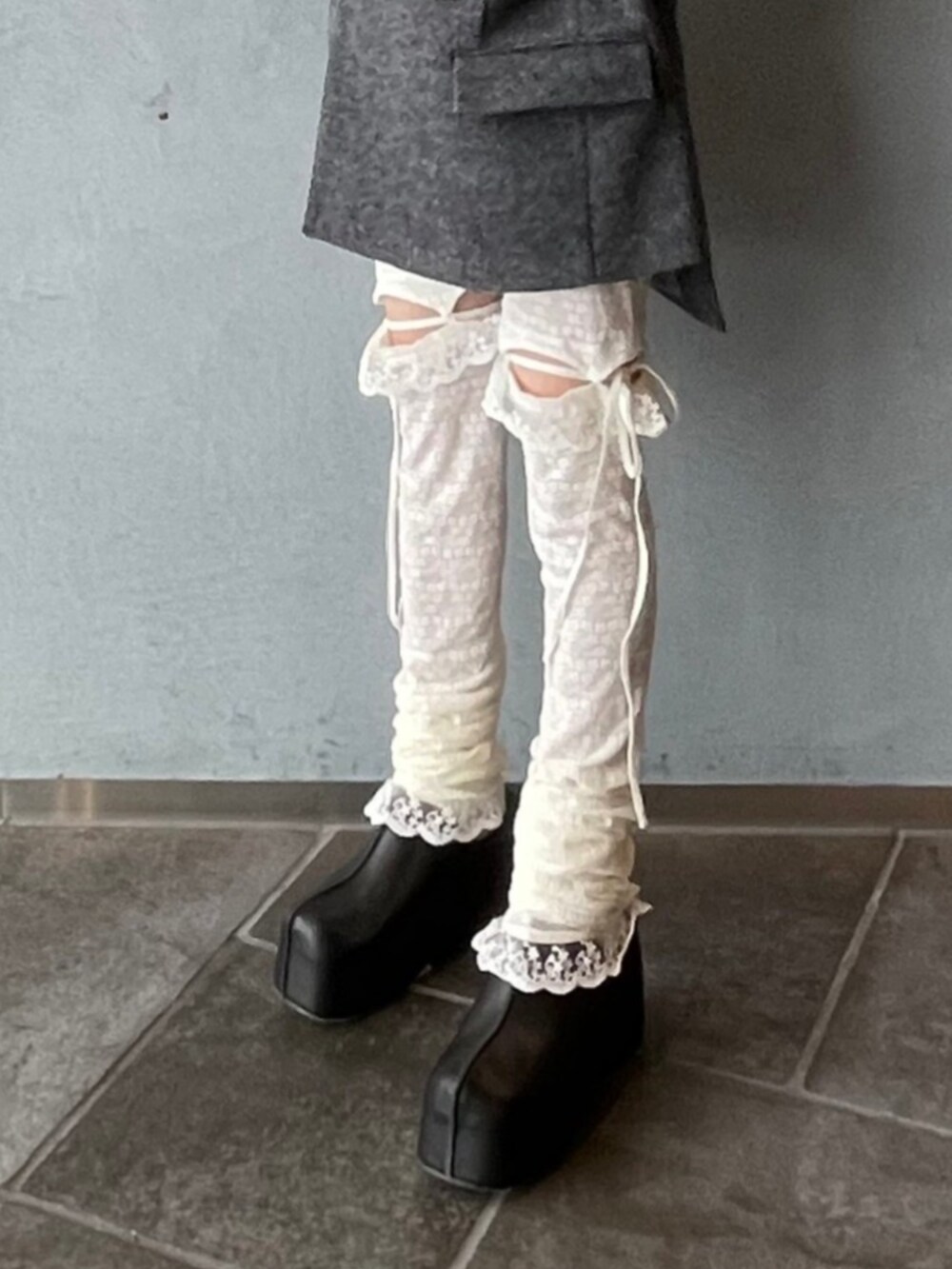 グレー系のテーラードジャケット、ブラック系のベルト、ホワイト系のタイツ/ストッキングを着用したレディースの秋コーディネートの6枚目の写真