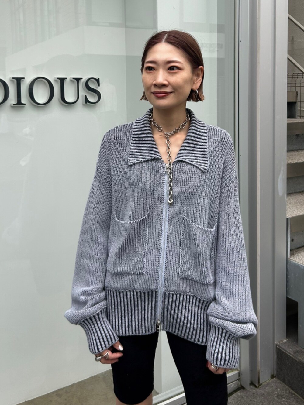 ブルー系のニット/セーターを着用したレディースの秋コーディネートの2枚目の写真