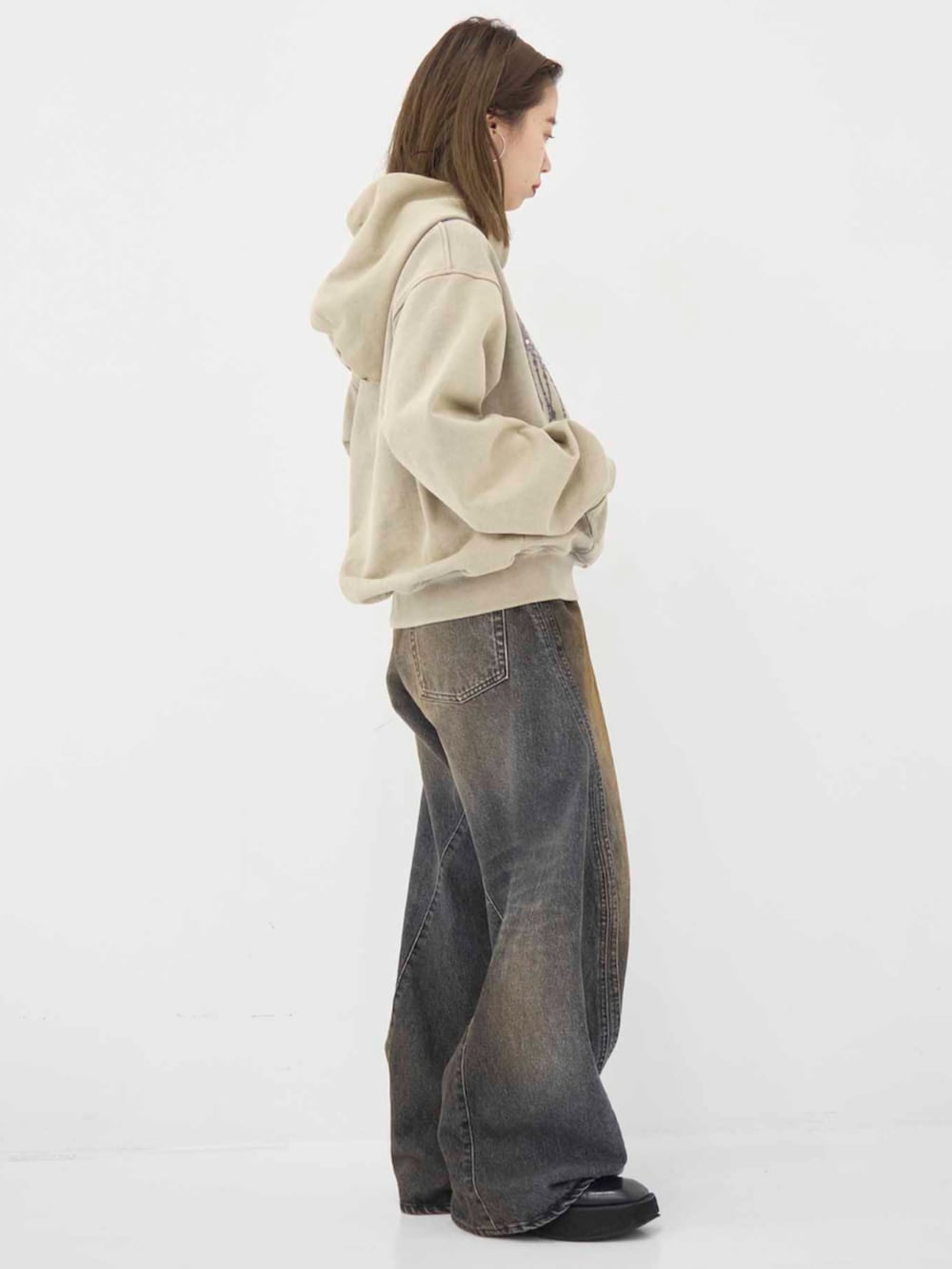 ベージュ系のパーカーを着用したレディースの冬コーディネートの4枚目の写真