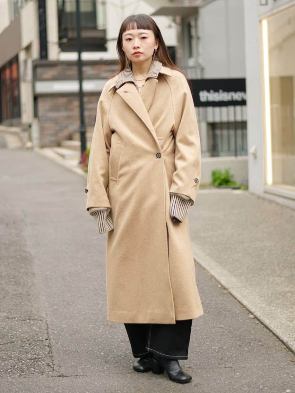 グリーン系のニット/セーター、イエロー系のその他アウターを着用したレディースの冬コーディネートの2枚目の写真