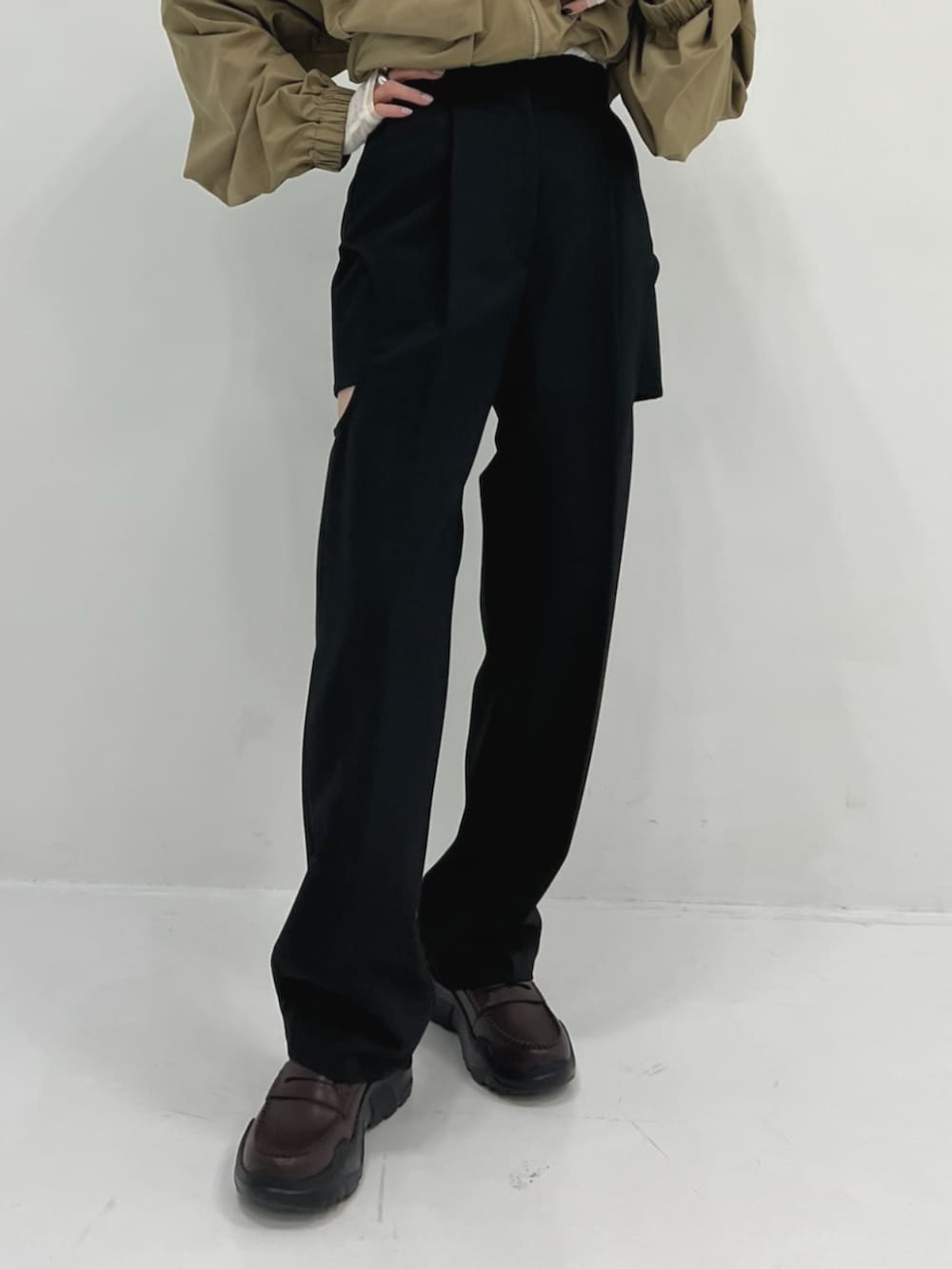 グリーン系のブルゾン、ブラウン系のローファー、ブラック系のその他パンツを着用したレディースの春コーディネートの3枚目の写真