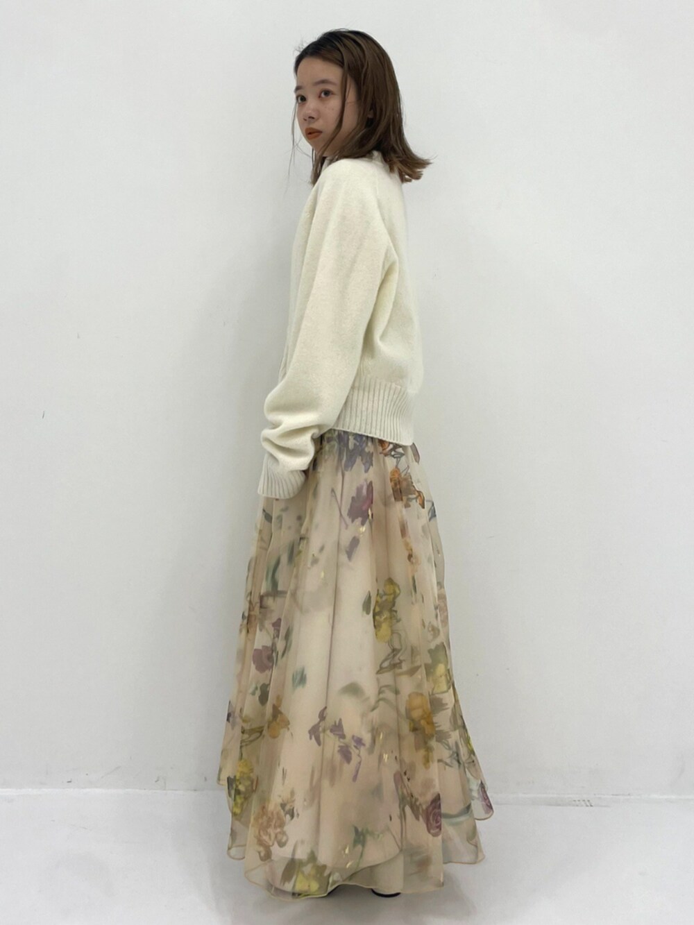 ホワイト系のニット/セーターを着用したレディースの秋コーディネートの2枚目の写真