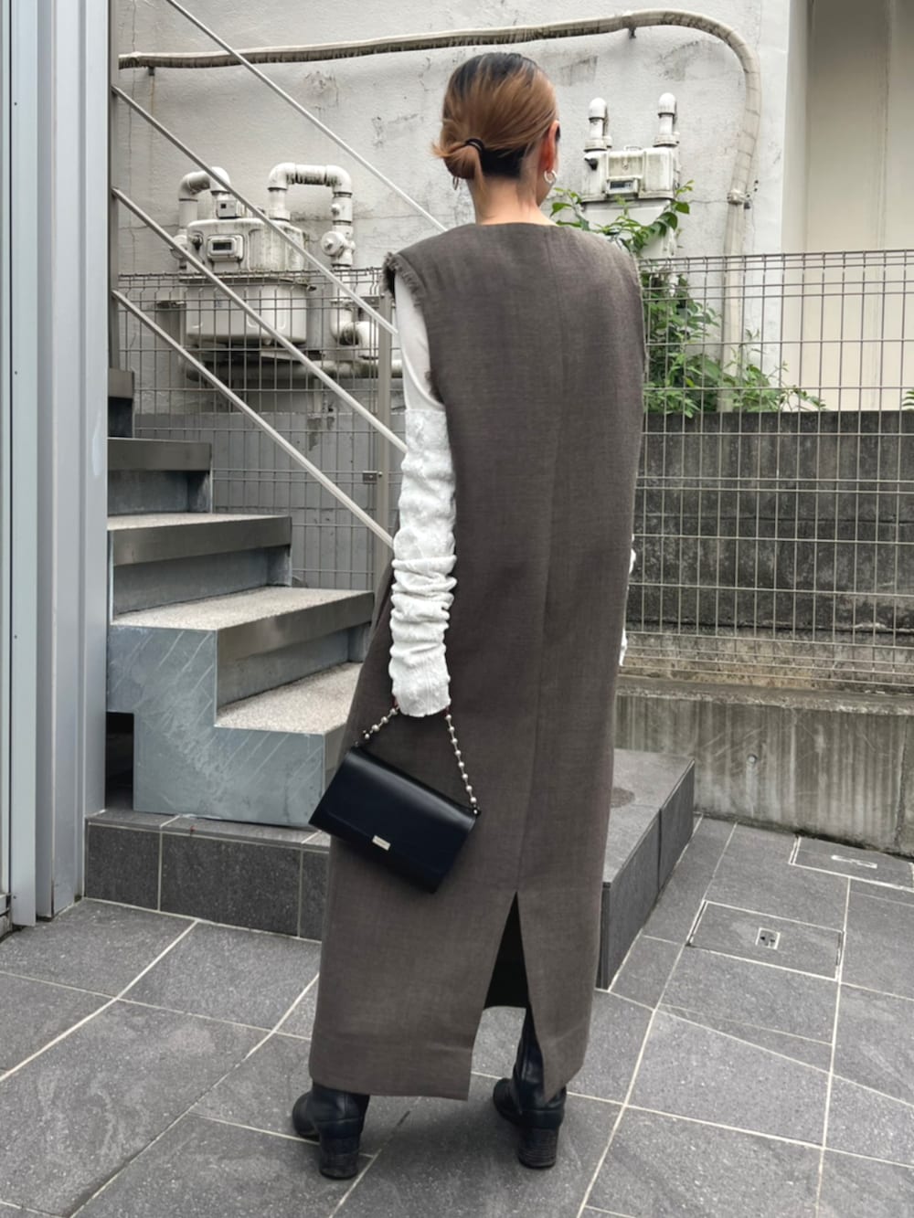 ベージュ系のワンピース、ホワイト系のアームカバーを着用したレディースの秋コーディネートの2枚目の写真