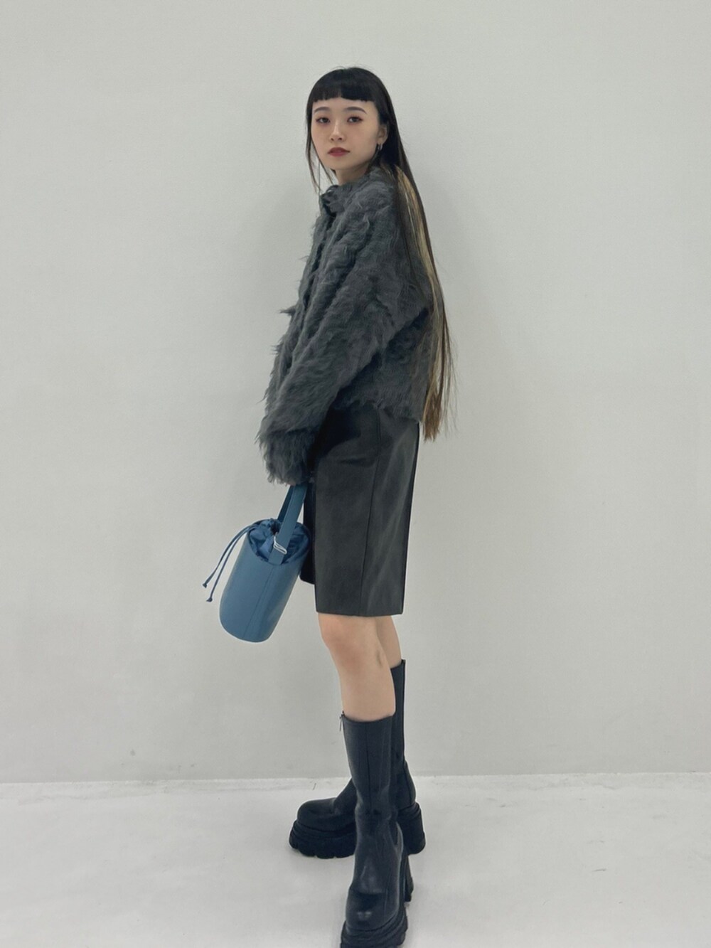 ブラック系のブーツ、ブラウン系のその他パンツ、グレー系のカーディガン/ボレロを着用したレディースの秋コーディネートの2枚目の写真