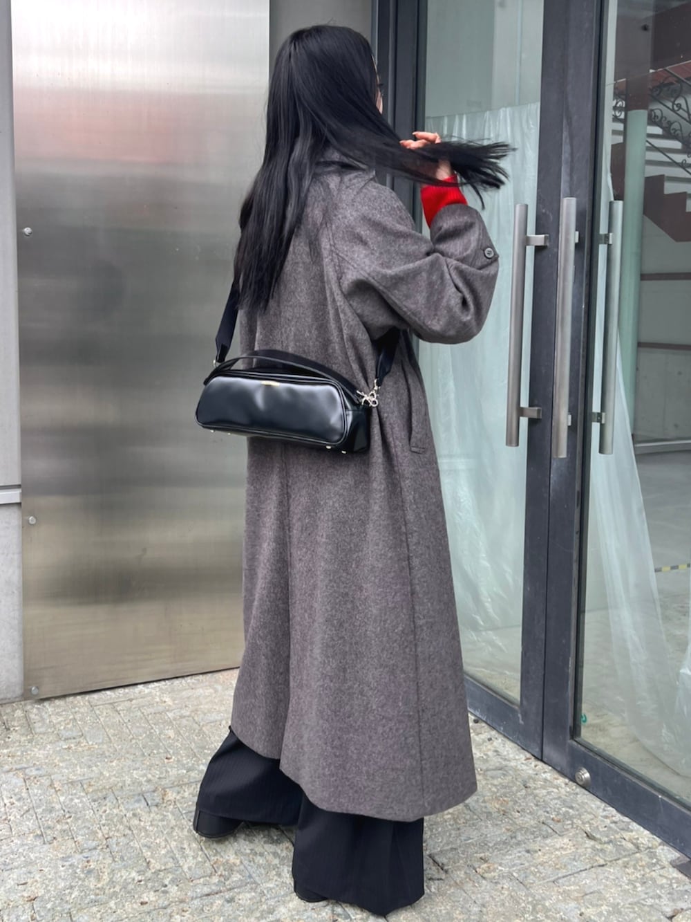 レッド系のニット/セーター、グレー系のその他アウターを着用したレディースの秋コーディネートの3枚目の写真