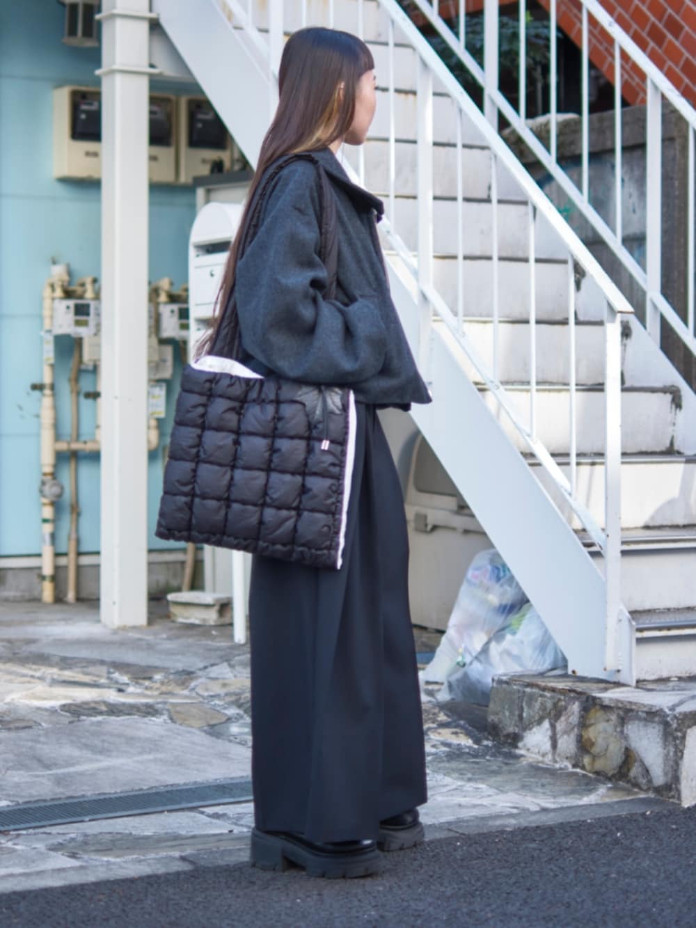 ブラック系のその他パンツ、グレー系のブルゾン、ブラック系のショルダーバッグを着用したレディースの冬コーディネートの2枚目の写真