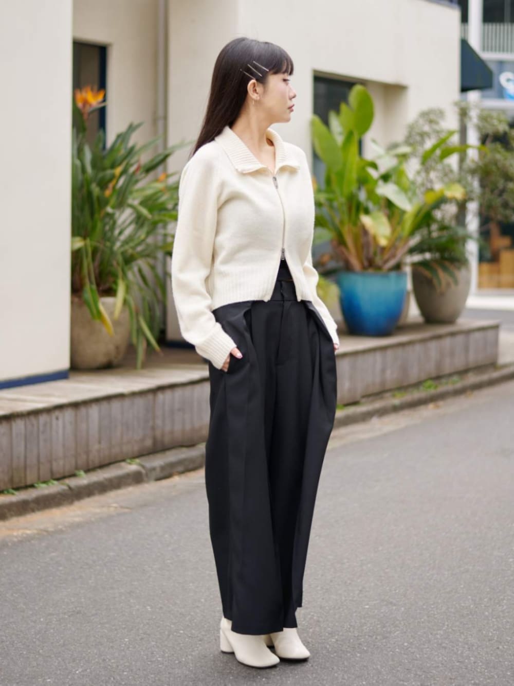 ホワイト系のニット/セーター、ブラック系のその他パンツを着用したレディースの冬コーディネートの2枚目の写真