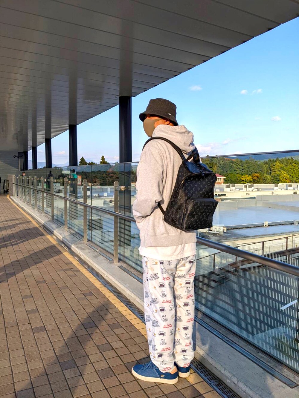 ブラック系のバックパック/リュック、グレー系のパーカー、ホワイト系のその他パンツを着用したメンズの秋コーディネートの2枚目の写真