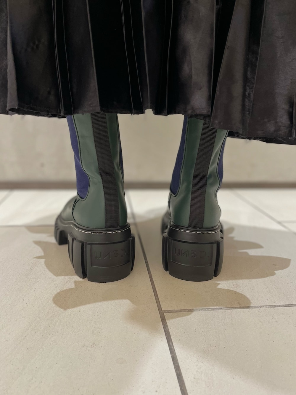 ブラック系のスカート、ホワイト系のシャツ/ブラウス、ブラック系のブルゾンを着用したレディースの秋コーディネートの7枚目の写真