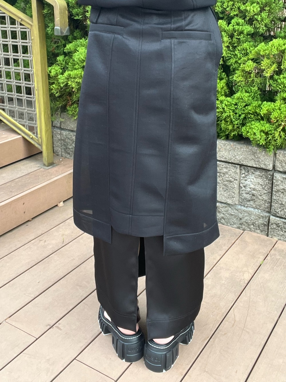 ブラック系のTシャツ/カットソー、ブラック系のスカート、ブラック系のサンダルを着用したレディースの春コーディネートの8枚目の写真