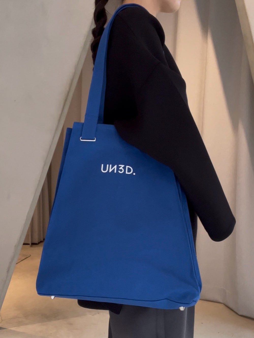 ブラック系のTシャツ/カットソー、ブルー系のトートバッグ、グレー系のその他パンツを着用したレディースの春コーディネートの4枚目の写真