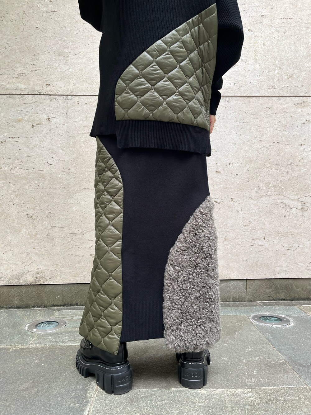 ブラック系のニット/セーター、ブラック系のスカート、ブラック系のローファーを着用したレディースの秋コーディネートの5枚目の写真