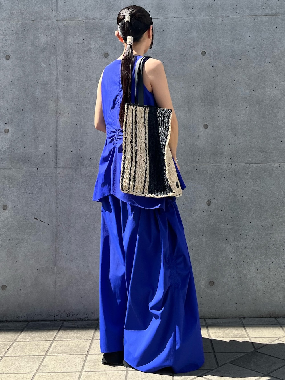 ブルー系のタンクトップ、ブルー系のその他パンツ、ブラック系のサンダルを着用したレディースの夏コーディネートの2枚目の写真