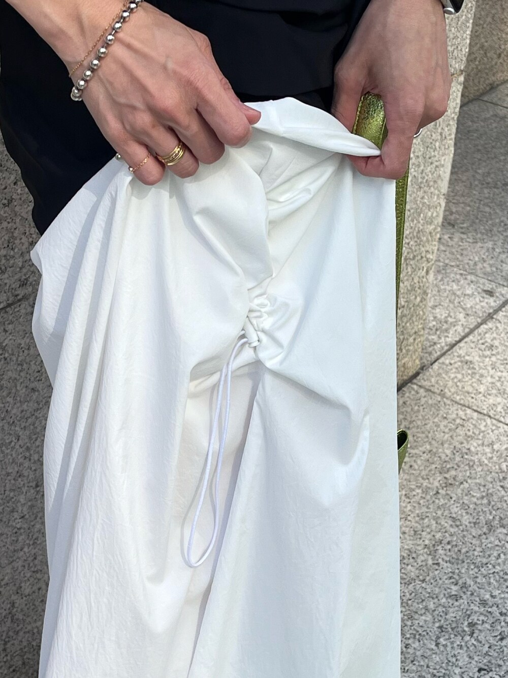 イエロー系のトートバッグ、ブラック系のTシャツ/カットソー、ホワイト系のその他パンツを着用したレディースの春コーディネートの6枚目の写真