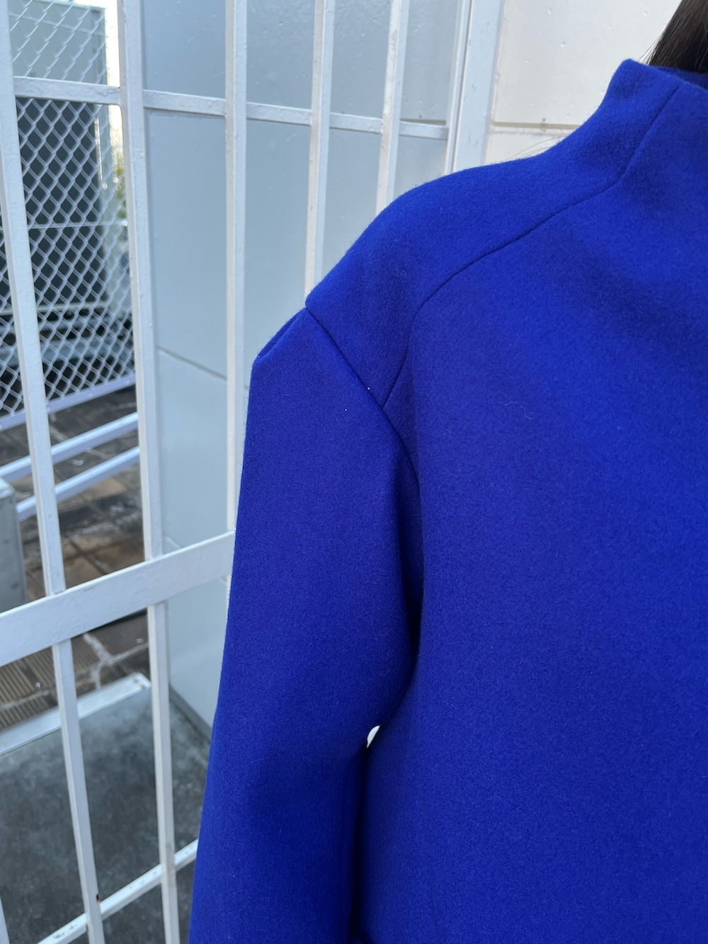 ブルー系のその他アウター、ブラック系のスカート、ブラック系のブーツを着用したレディースの冬コーディネートの6枚目の写真