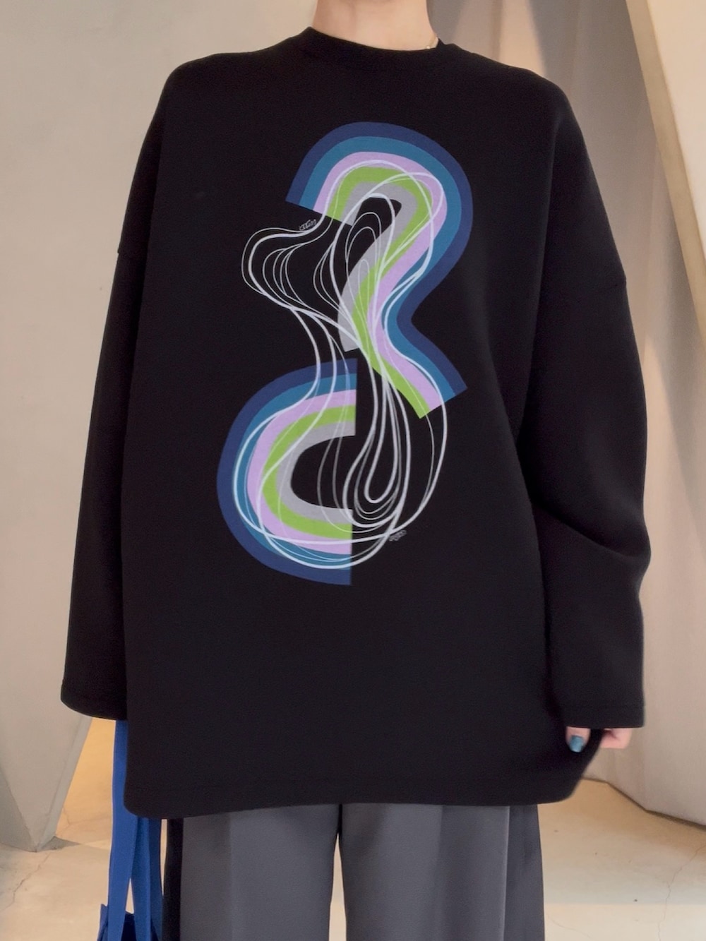 ブラック系のTシャツ/カットソー、ブルー系のトートバッグ、グレー系のその他パンツを着用したレディースの春コーディネートの3枚目の写真