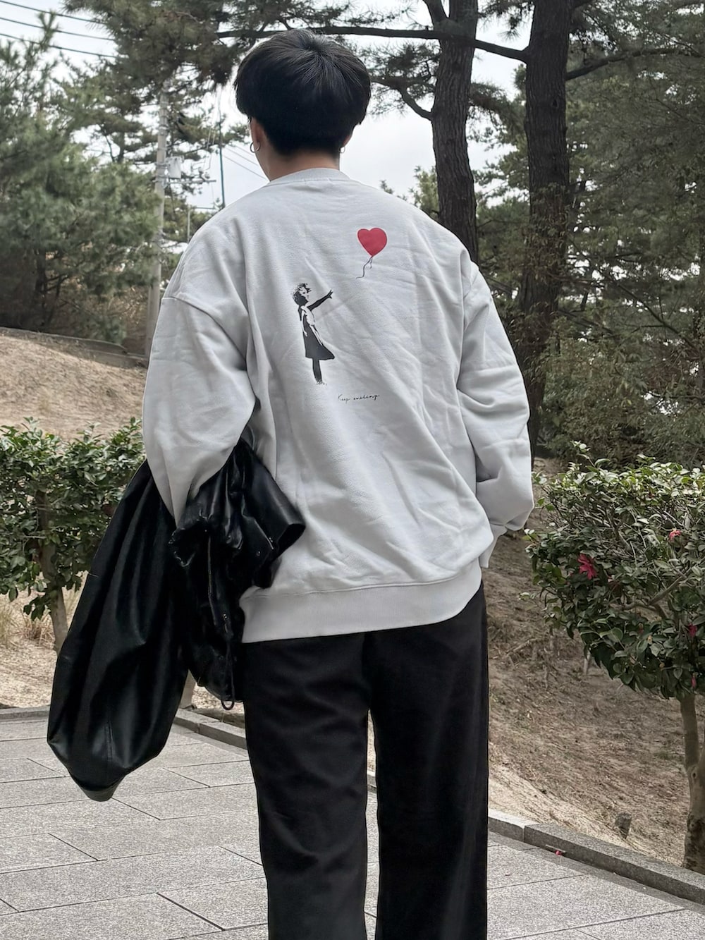 ブラック系のスラックス、ブラック系のブーツ、ブラック系のブルゾンを着用したメンズの冬コーディネートの3枚目の写真