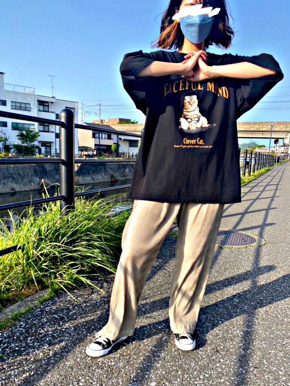 ブラック系のTシャツ/カットソー、ブラック系のスニーカー、ベージュ系のその他パンツを着用したレディースの春コーディネートの3枚目の写真