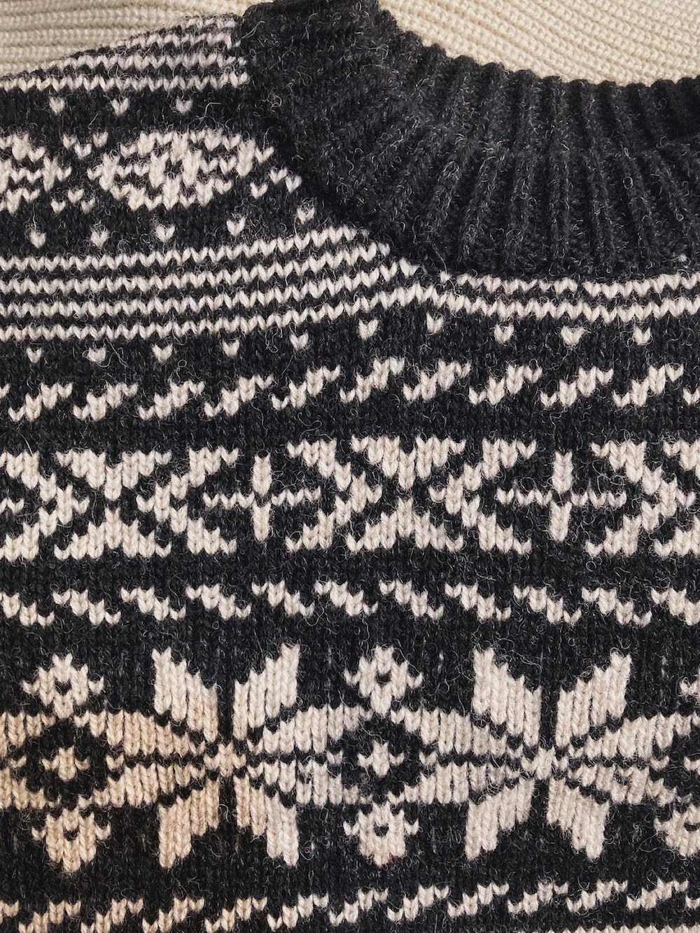 グレー系のスラックス、ブラック系のスニーカー、ブラック系のニット/セーターを着用したメンズの秋コーディネートの2枚目の写真