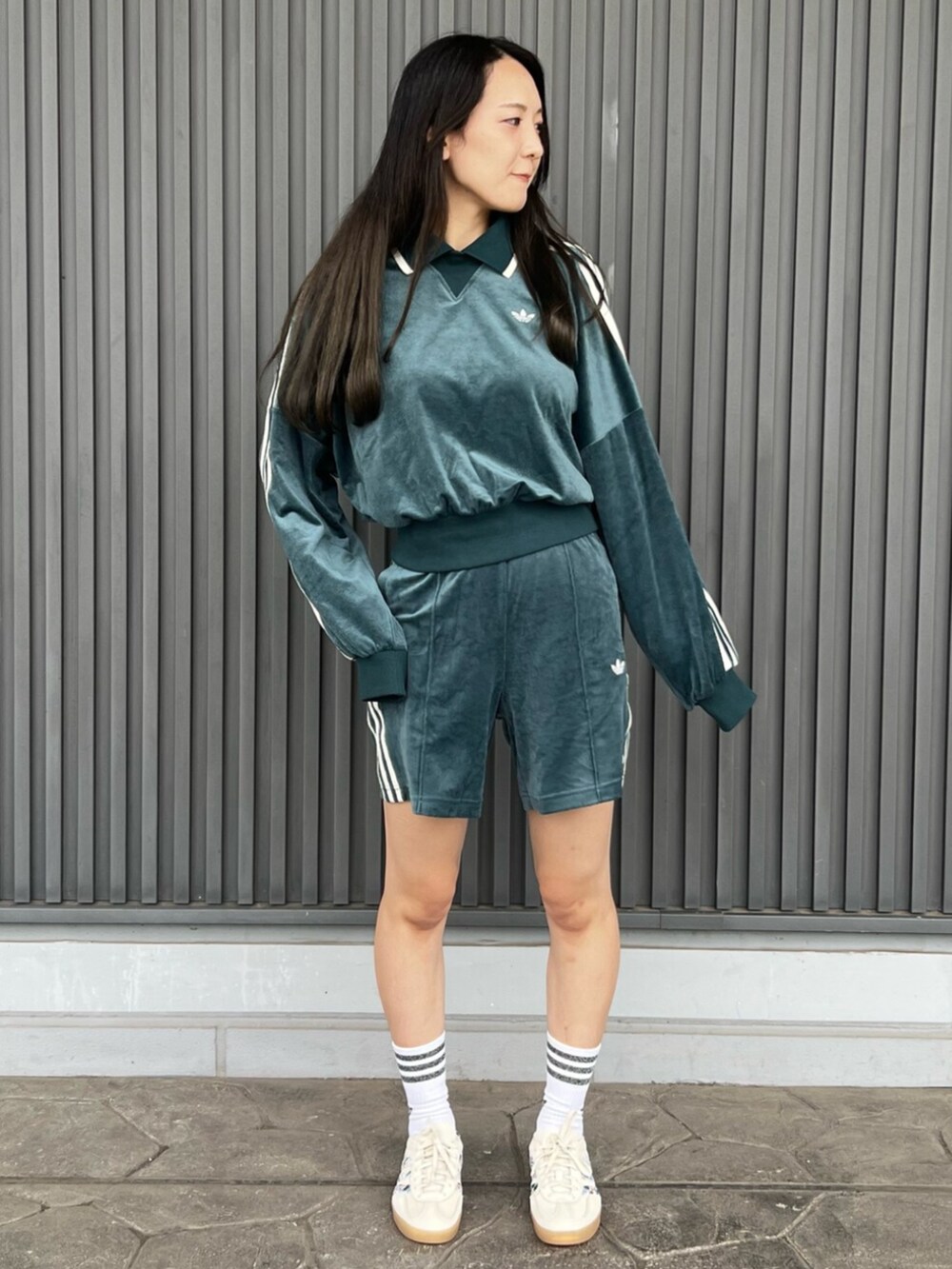 グリーン系のスウェット、グリーン系のその他パンツ、ホワイト系のシューズを着用したレディースの秋コーディネートの2枚目の写真