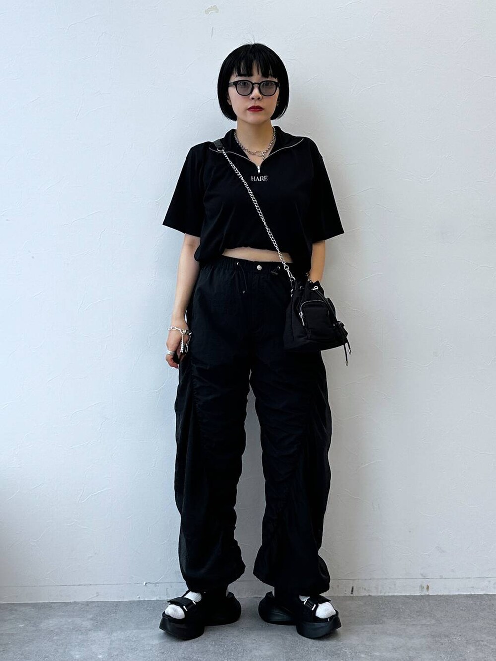 ブラック系のサンダル、ブラック系のTシャツ/カットソー、ブラック系のショルダーバッグを着用したレディースの夏コーディネートの6枚目の写真