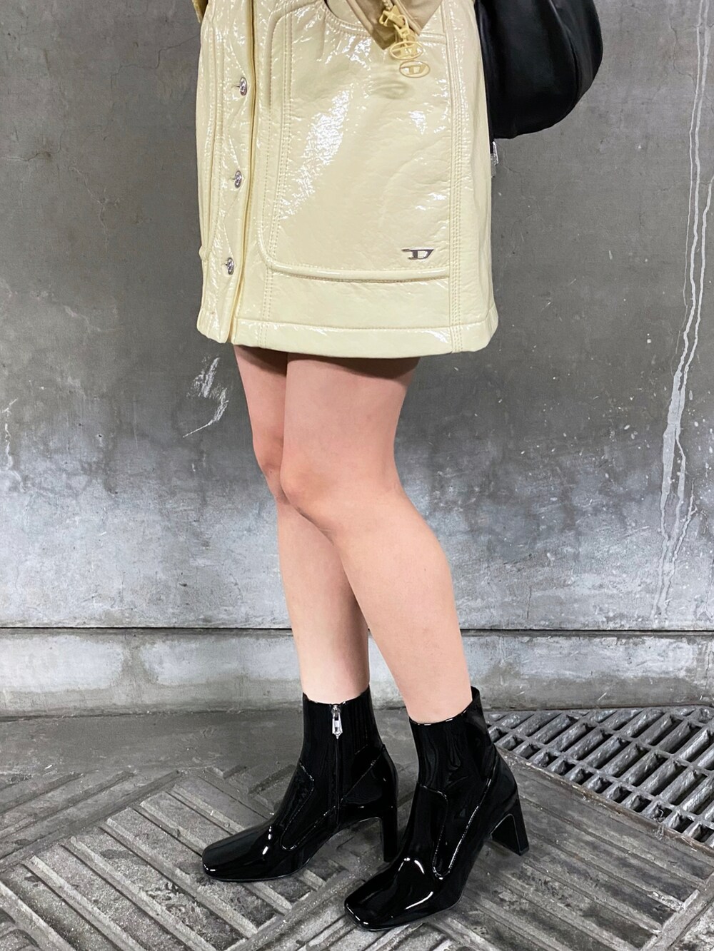 ベージュ系のダウンジャケット/コート、ホワイト系のニット/セーター、ホワイト系のスカートを着用したレディースの冬コーディネートの3枚目の写真