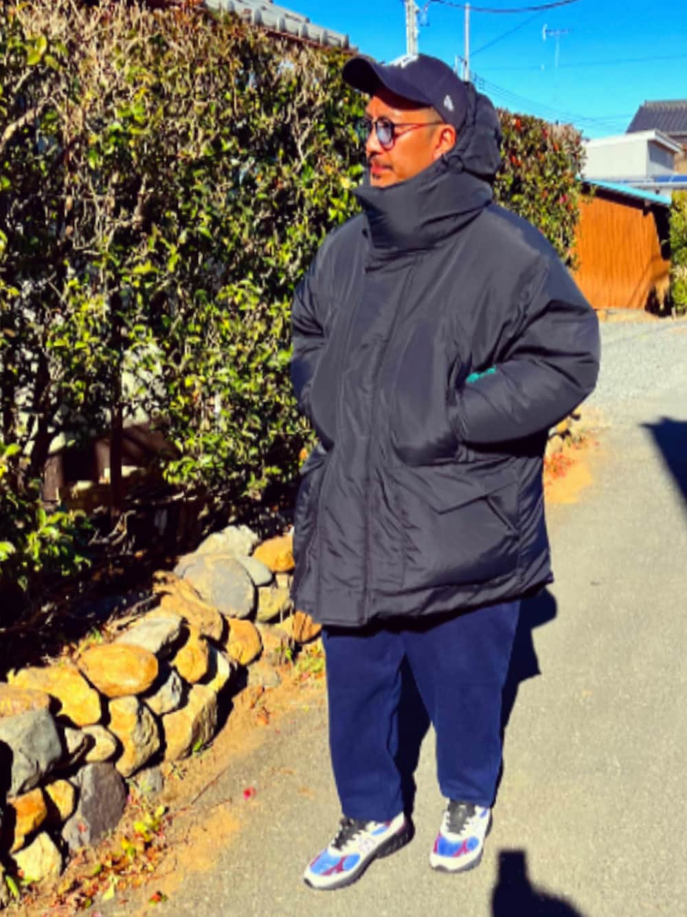 ブラック系のダウンジャケット/コート、ブラック系のダウンベスト、ホワイト系のTシャツ/カットソーを着用したメンズの冬コーディネートの2枚目の写真