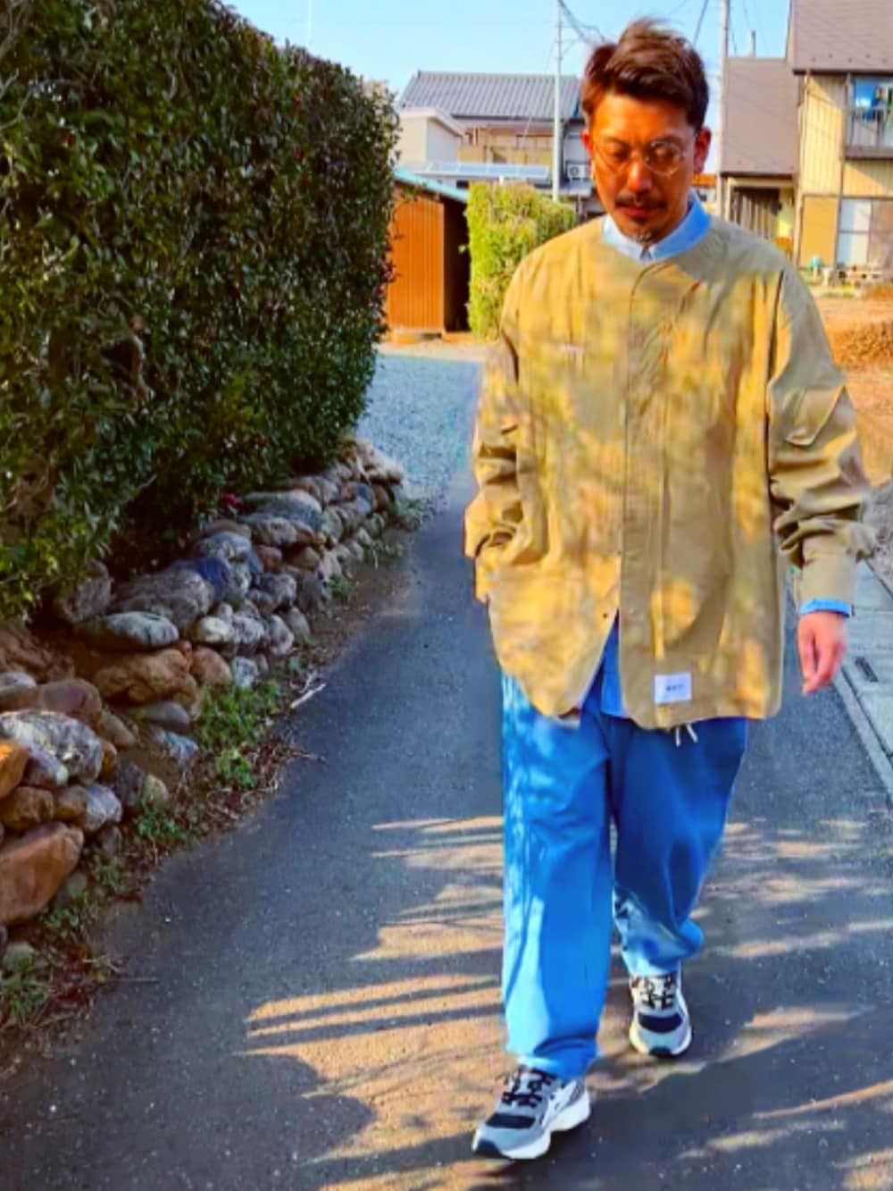 ベージュ系のシャツ/ブラウス、ブルー系のシャツ/ブラウス、ブルー系のデニムパンツを着用したメンズの春コーディネートの3枚目の写真